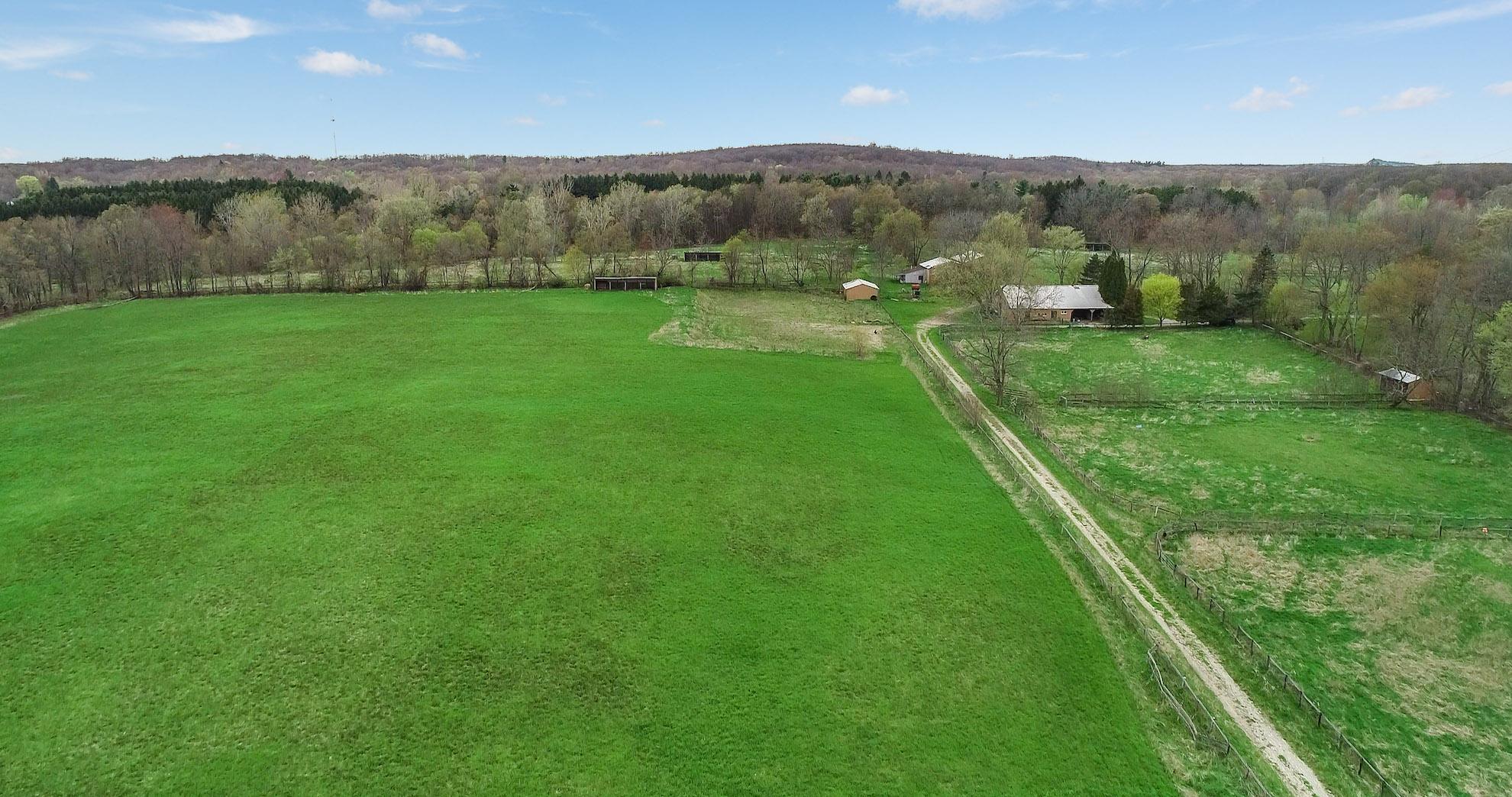 Open pastures and horse barns on 83 acres in Clarkston