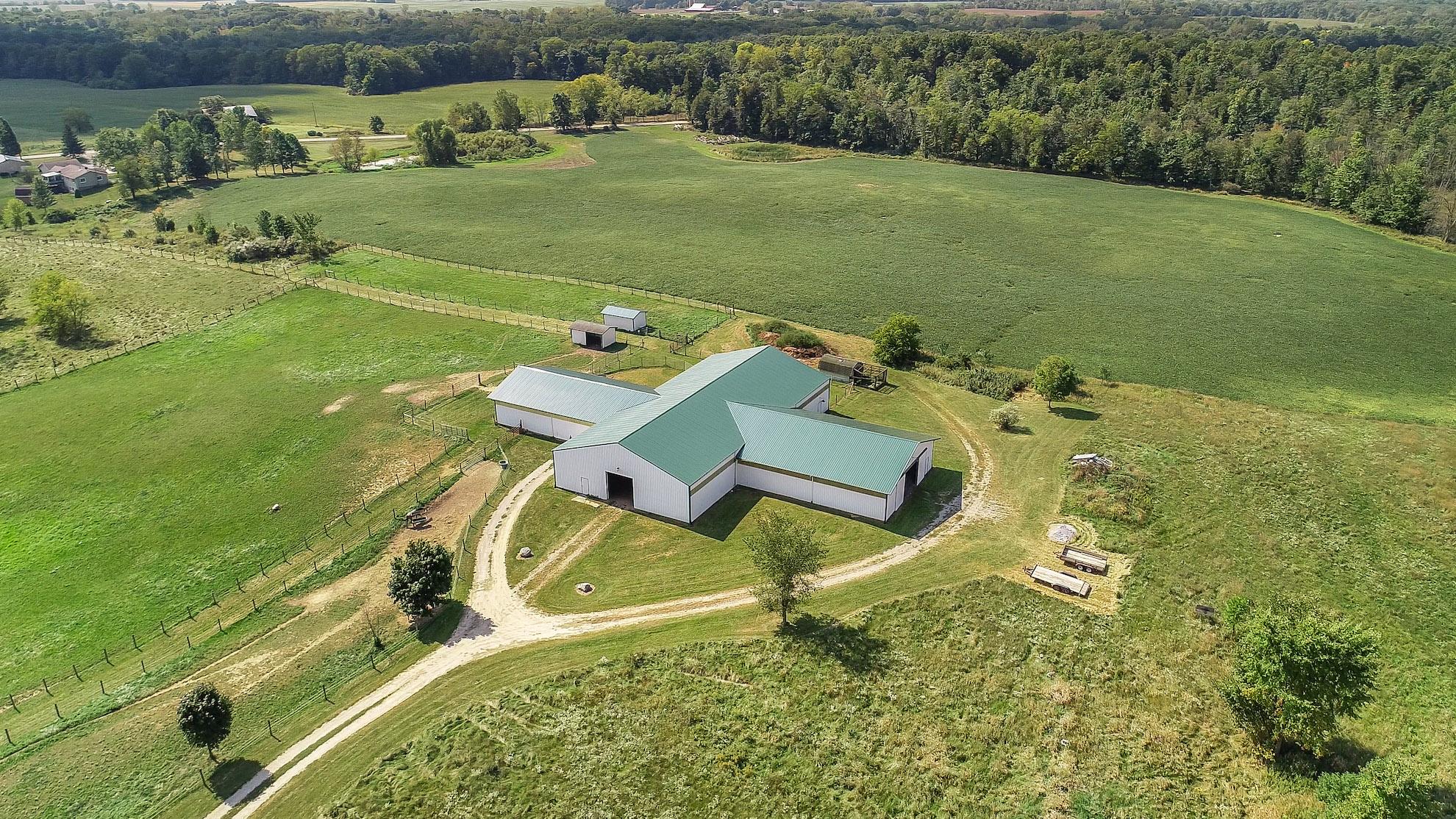 Aerial view of a barn surrounded by pastures in Macomb County
