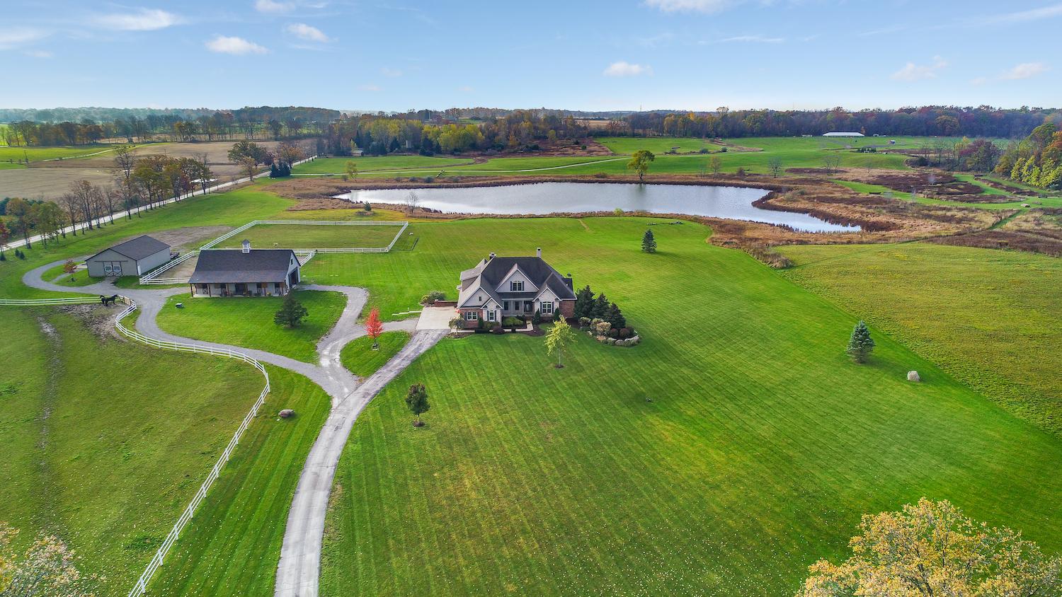 Aerial view of a home, pond and pastures in Dexter