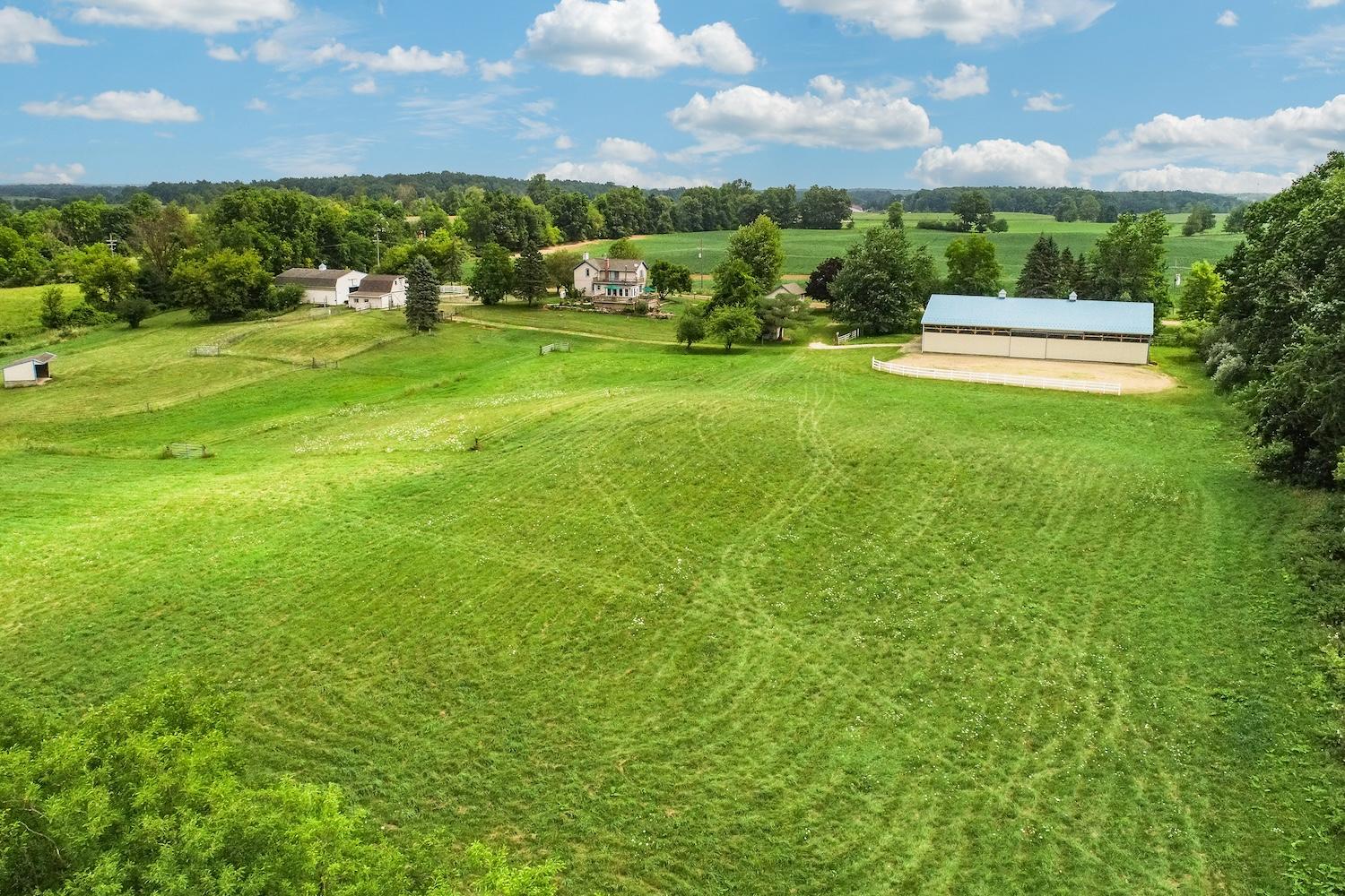 Aerial view of pastures and the indoor arena at 7310 Steinbach Road in Manchester